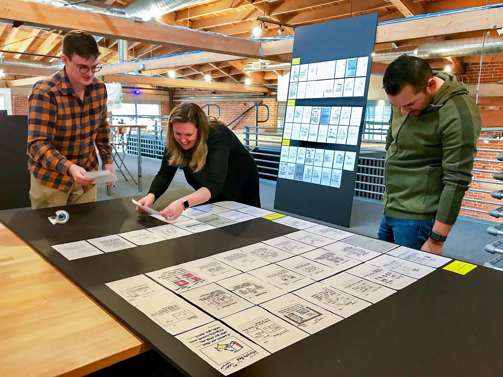 UX consultants prepare concept cards for an upcoming workshop on the mezzanine level of our San Diego design studio.