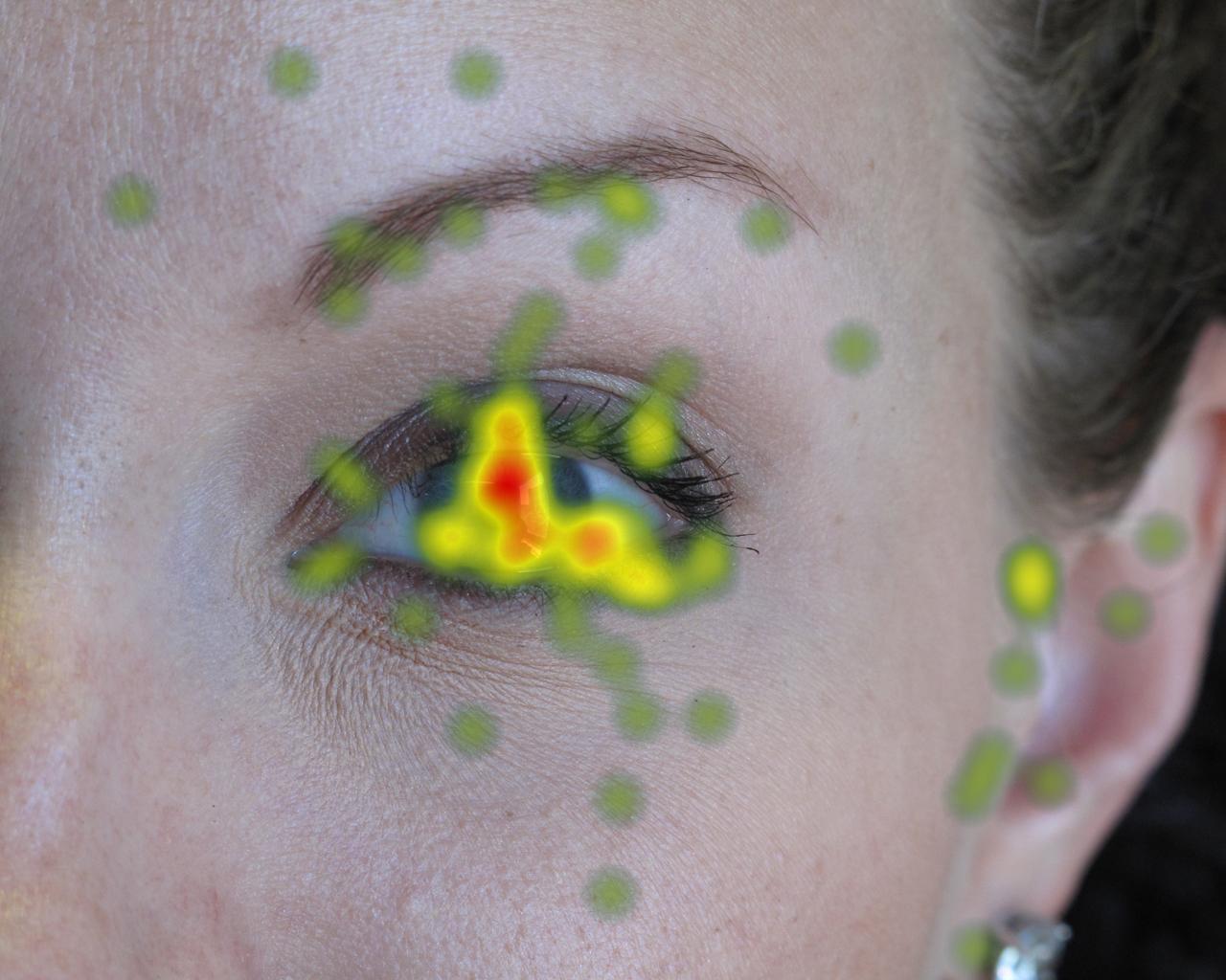 Eye tracking heatmap overlaid over a woman's face.