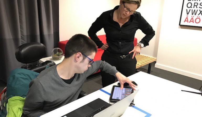 A Blink staff member observing an accessibility research study participant