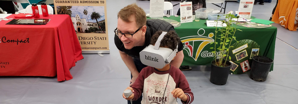 Blink team member with a young boy wearing a VR headset