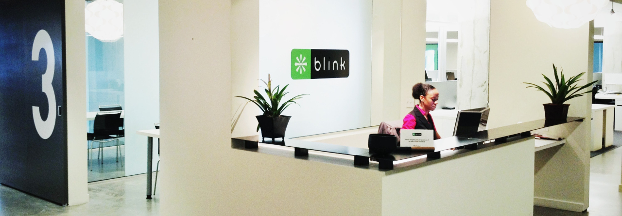 Blink team member sitting at the office front desk