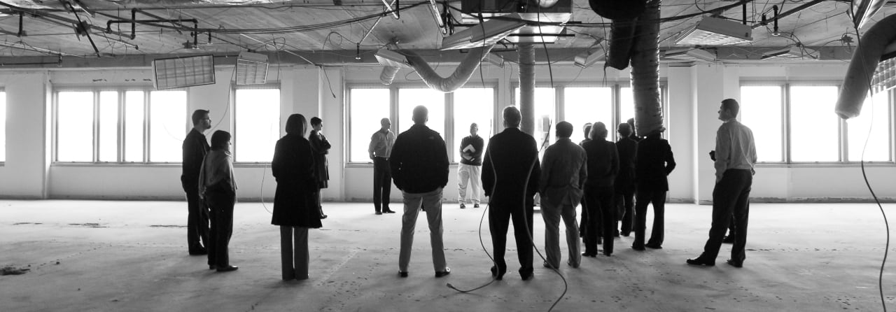 Black and white photo of Blink team members in a new office building