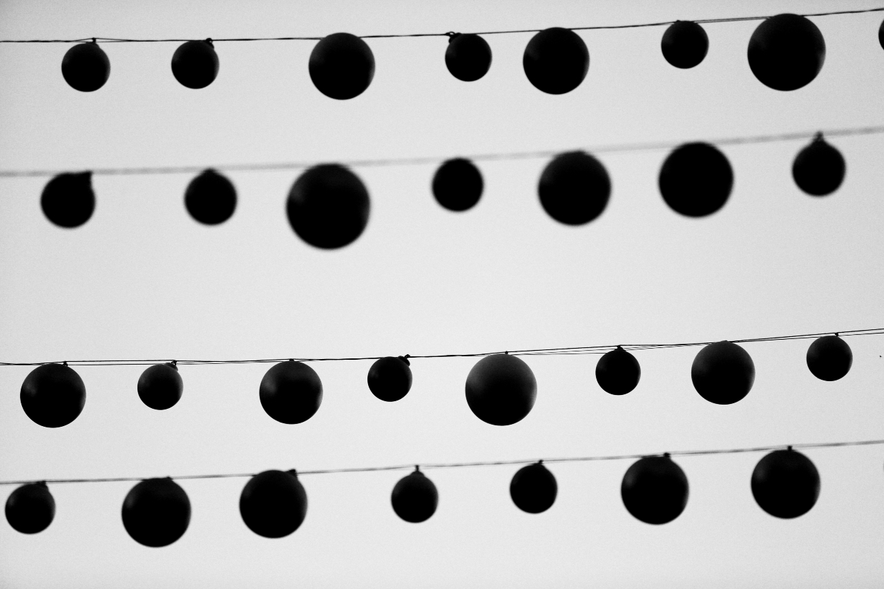 Black and white image of exterior hanging round decorations