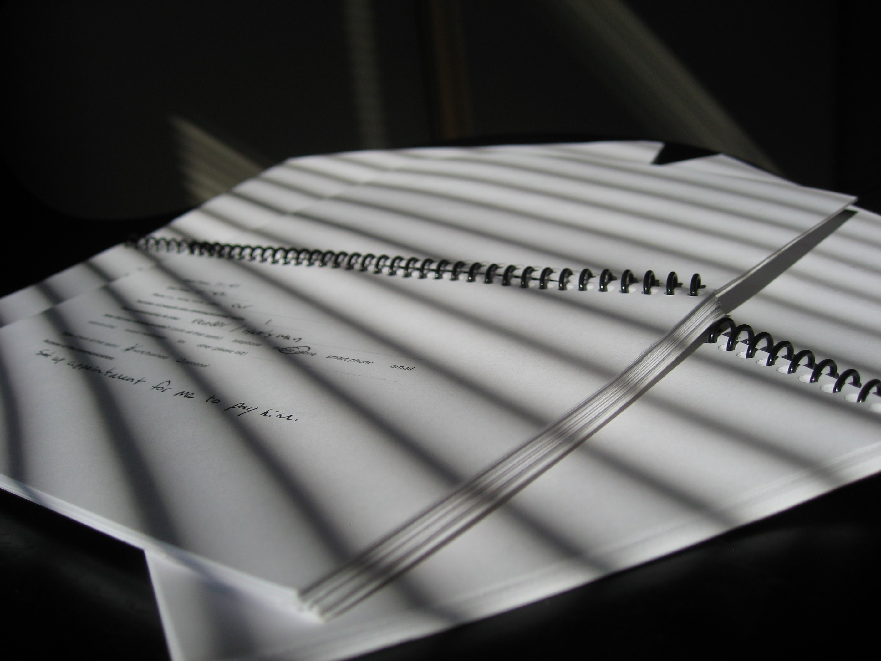 Shadows falling on a group of notebooks