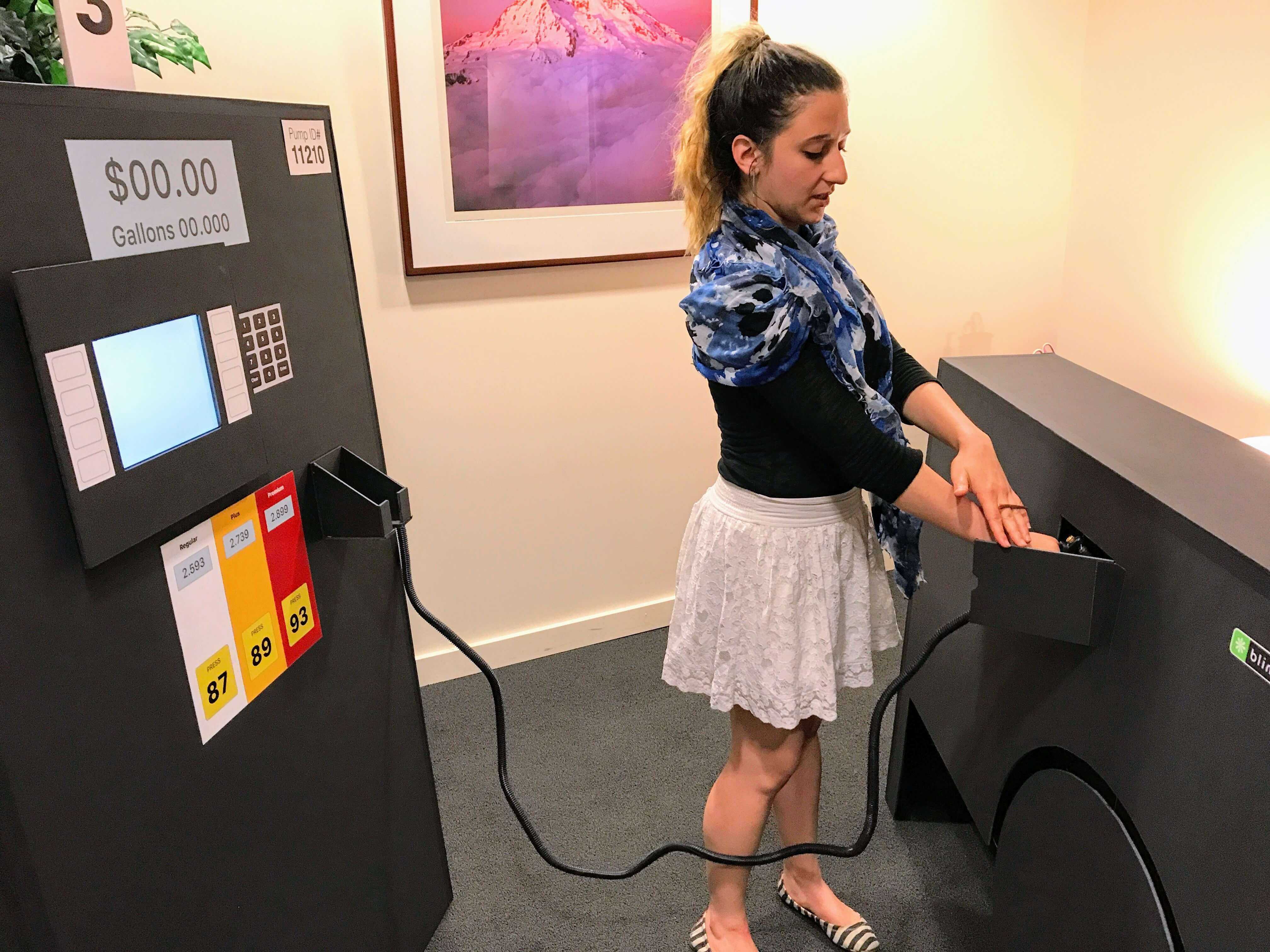 Usability testing participant using a prototype gas station pump in a Blink lab