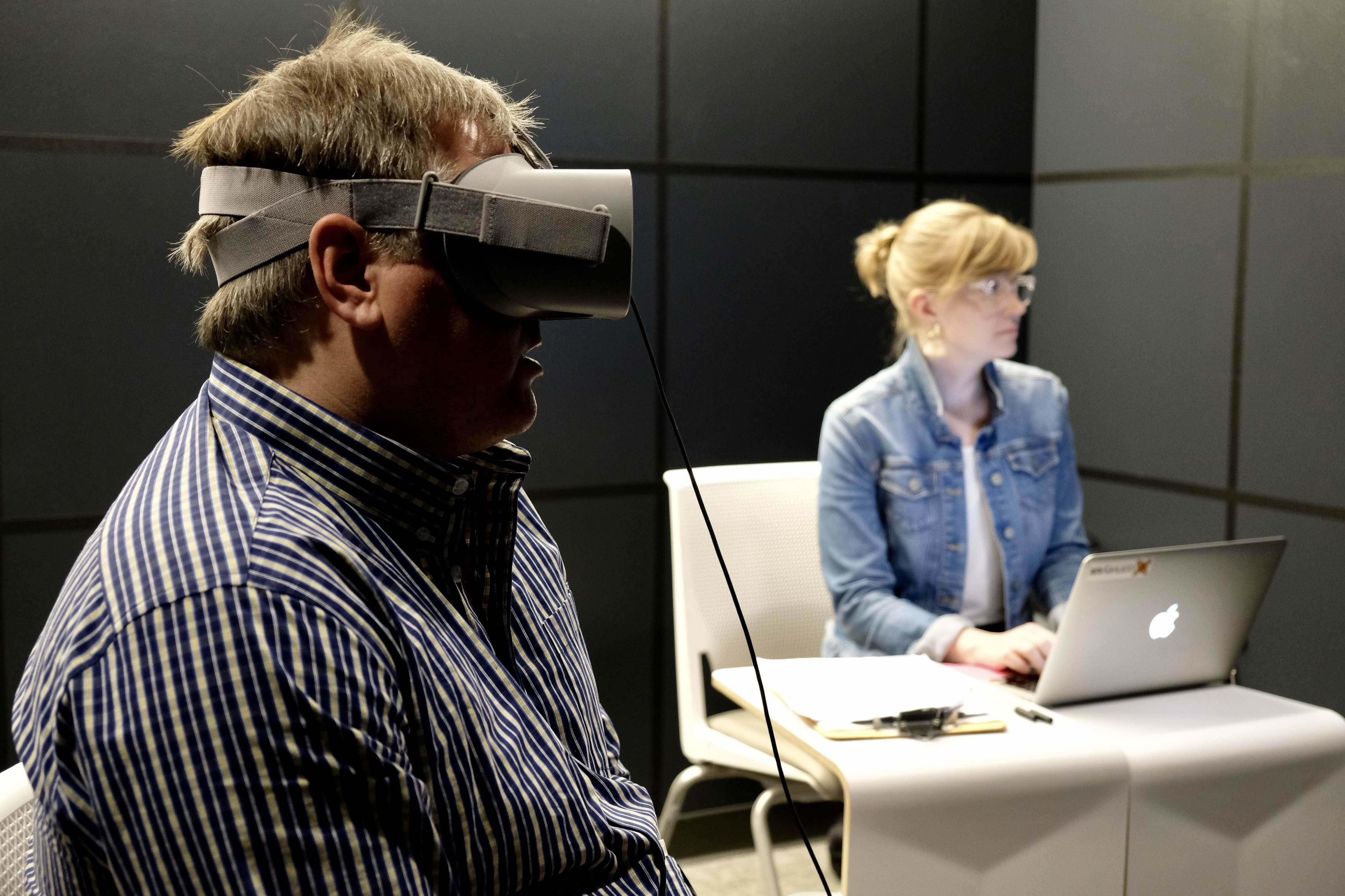 Man wearing virtual reality headset undergoing user research testing.