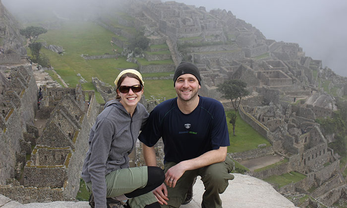 Man and woman posing at Machu Picchu.