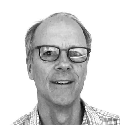A closely cropped black & white headshot of Michael Harding