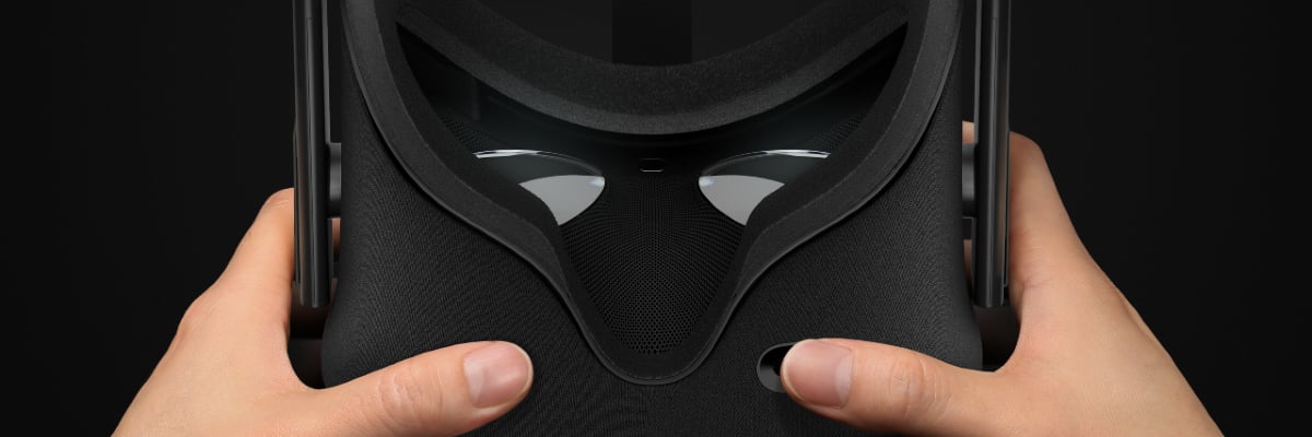 Hands holding an Oculus Rift virtual reality device.