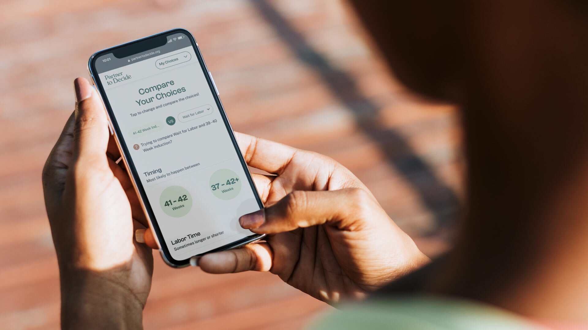 Person holding a phone looking at the new Partner to Decide mobile app