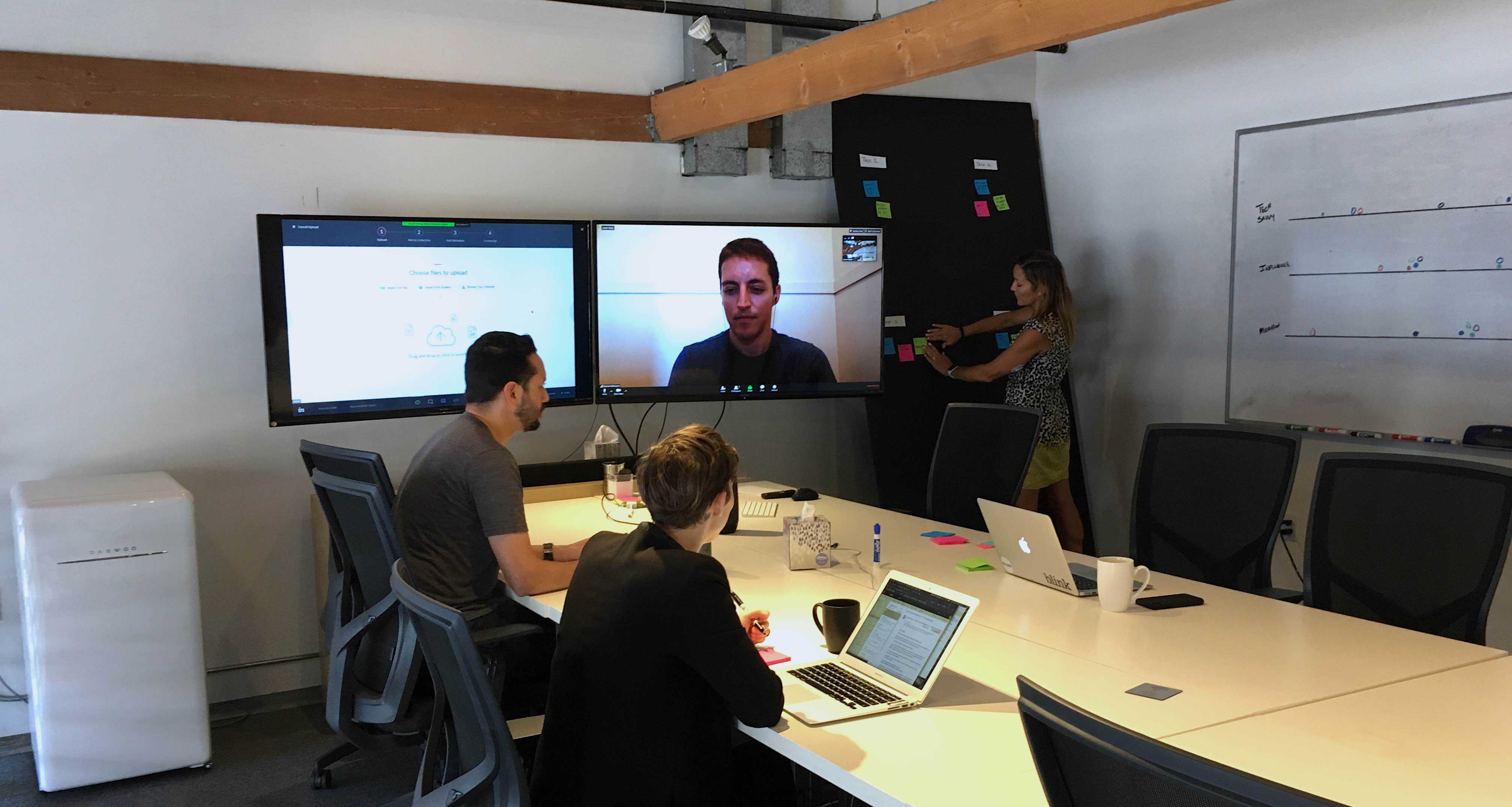Three clients record collaborate while watching a user research participant use an interactive prototype.