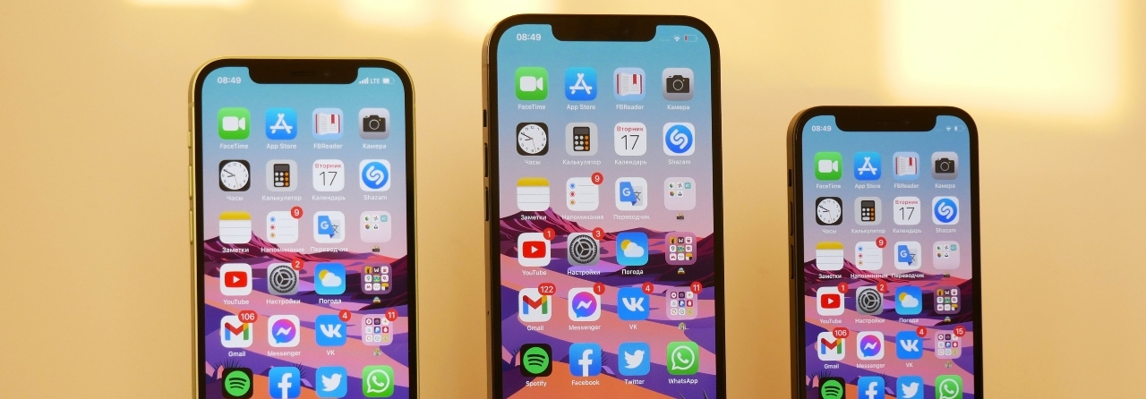 Home screens of three Apple iPhones.