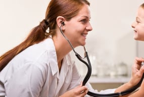 Doctor listening to a child's heartbeat with a stethoscope.