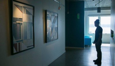 A photo of someone looking at the art gallery in the Blink lobby