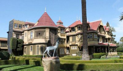 A picture of a mansion with elaborate landscaping