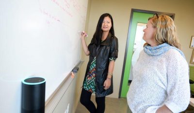 Two Blink employees collaborate on a whiteboard to create an Alexa skill