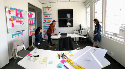 Designers at Blink collaborating on an experience map