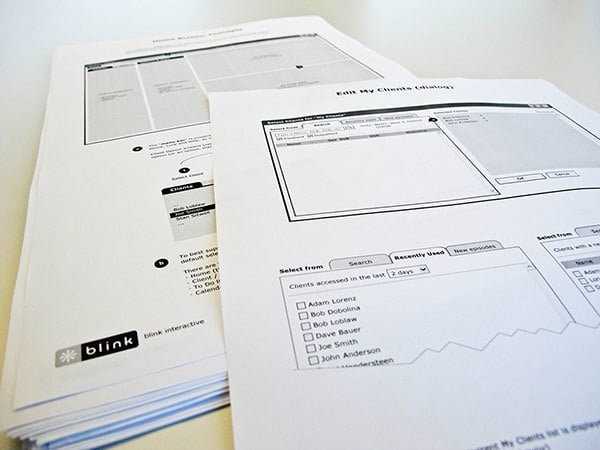 Black and white wireframes printed on paper.