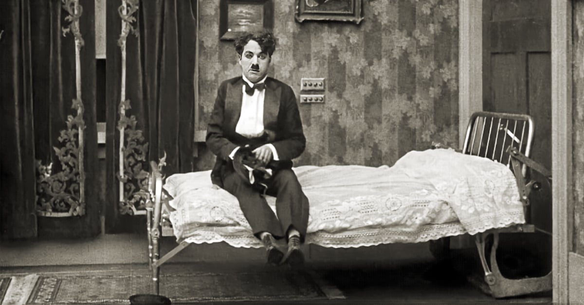 Charlie Chaplin sitting on a Murphy bed