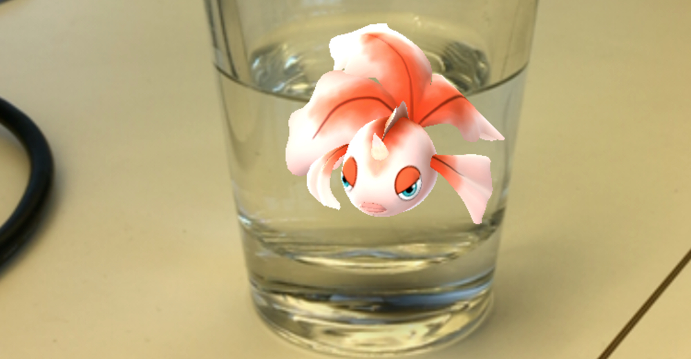 Augmented reality Pokémon in front of a glass of water.