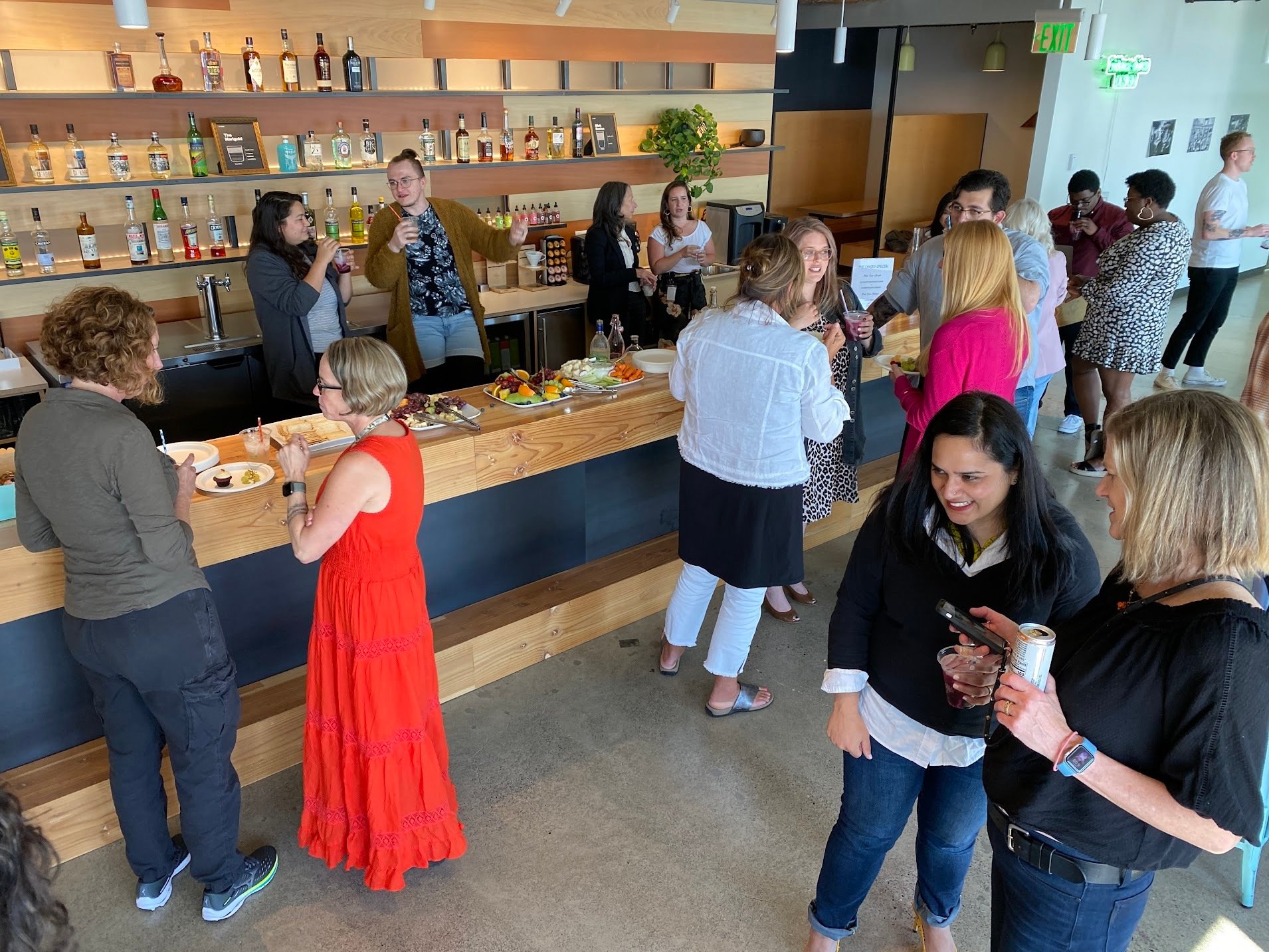 Blink employees stand in the main hall of our Seattle Studio for a studio-wide happy hour.
